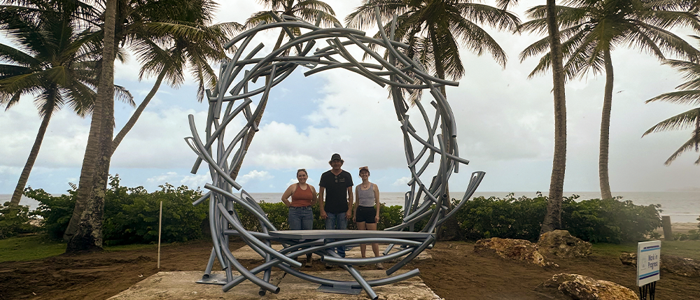 Danielle Sisson, Luis Torruella, and Elizabeth Kelly behind the scultupture.