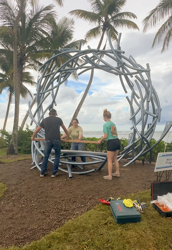 Luis, Danielle, and Elizabeth installing the sculpture’s wooden bench.