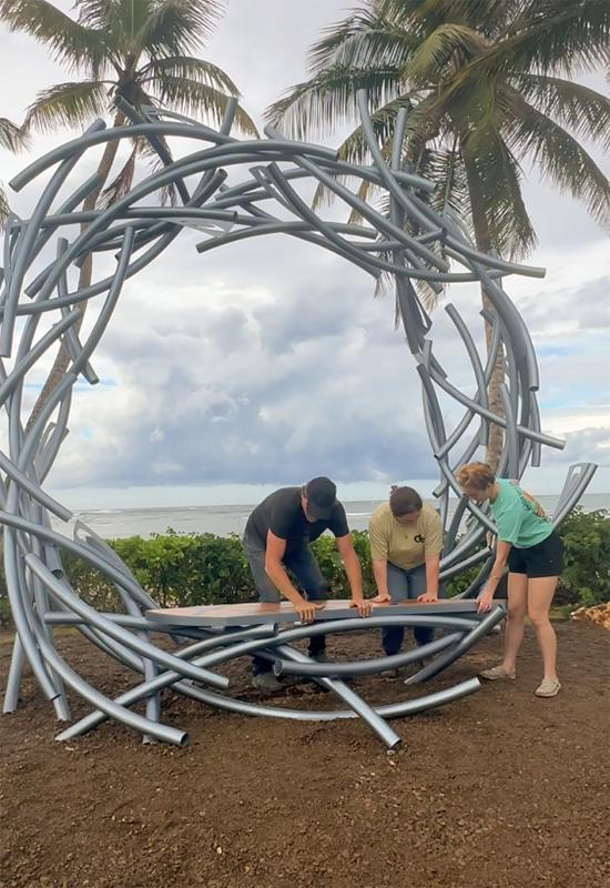 Luis, Danielle, and Elizabeth installing the sculpture’s wooden bench.