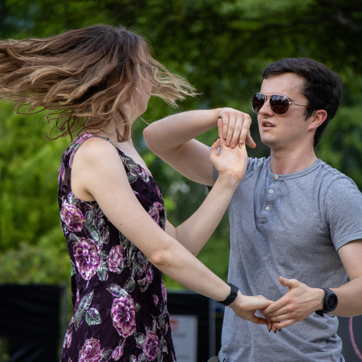 two people dancing and spinning each other