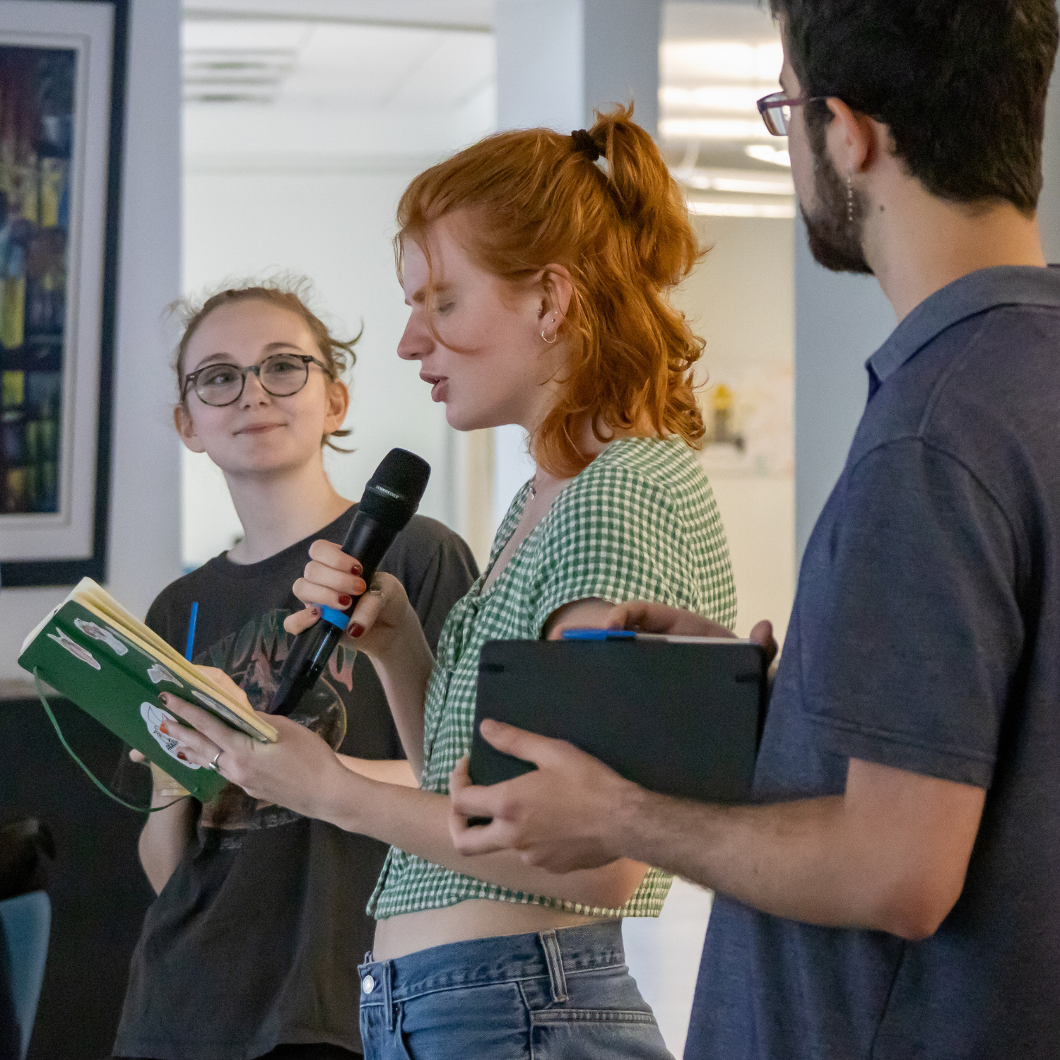 One person reading poetry to room with onlookers