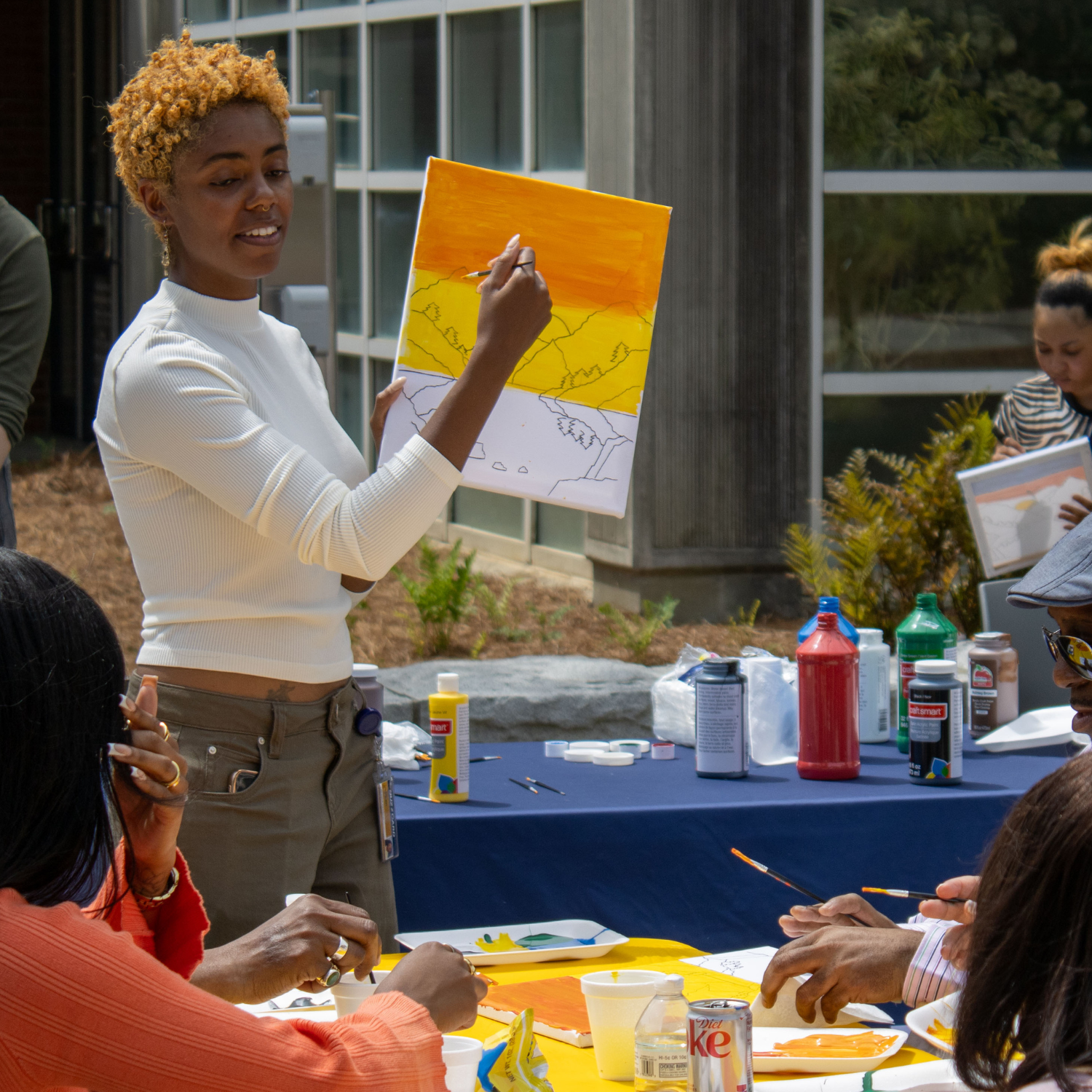 Person pointing to painting and guiding group