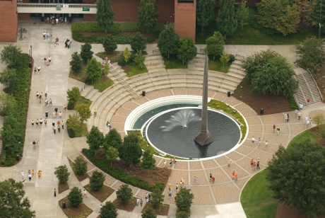 Aerial view of the 80 foot tall stainless steel spire based in a pool of water with fountain spray