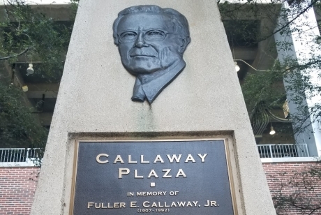 Bas relief of the face of Fuller E. Callaway, Jr. on a cement tower, above a plaque recounting his devotion and dedication to Georgia Tech