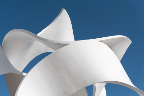 The Koan sculpture by John Portman, bright white undulating ribbons of steel against a blue sky