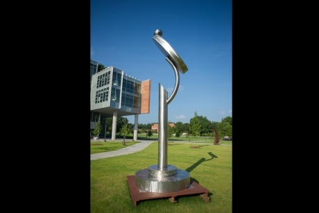 Steel pole on a multi-layered circular steel base with a mirror-like protrusion on top