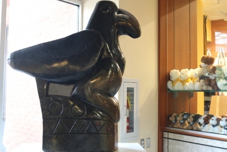 smooth black Springstone Serpentine sculpted in shape of a bird perched on a pedestal inscribed with geometric shapes