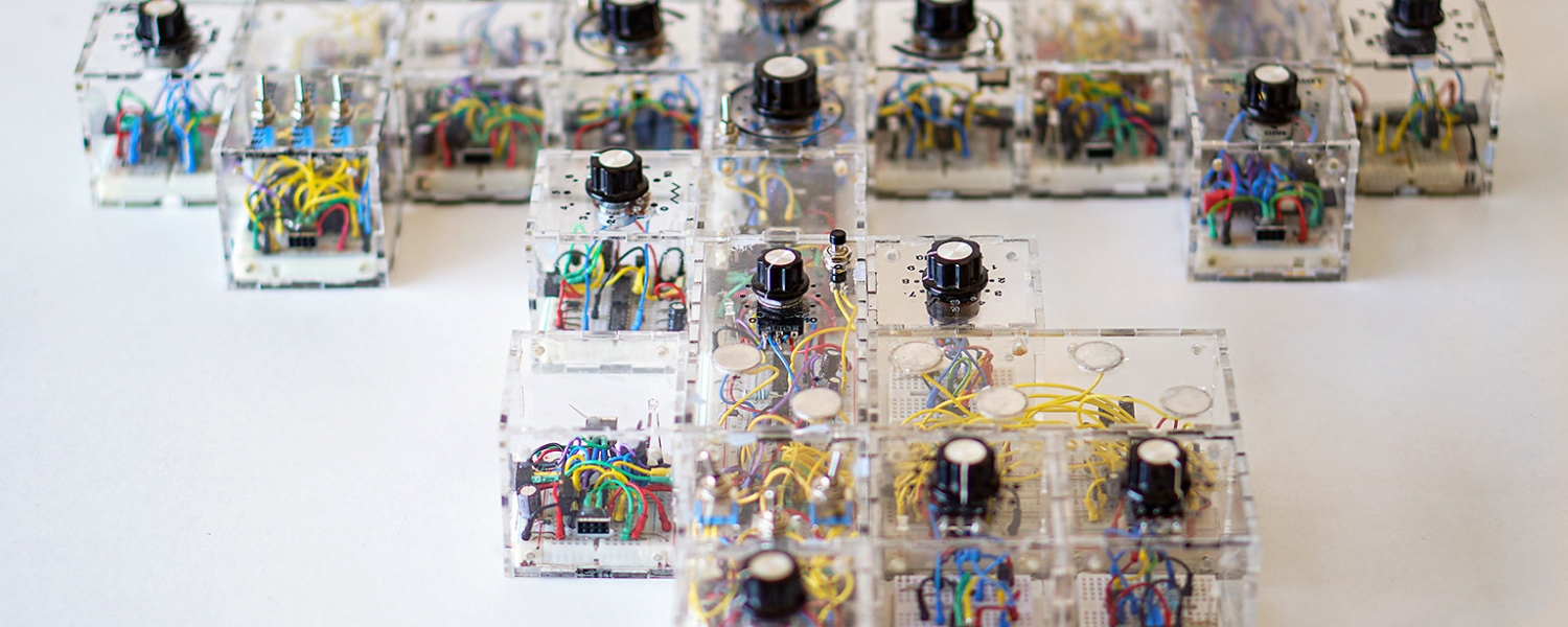 an arrangement of clear square cubes eah with wires and a knob.