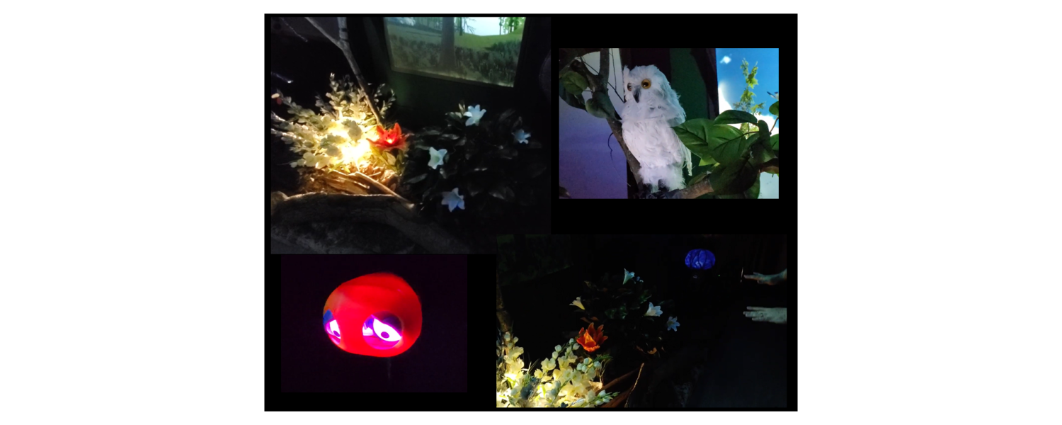 a dark room with video projections, animatronic objects, and an upside down umbrella displaying video of a blue sky and trees