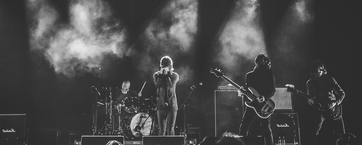 Black and white photo of a rock group performing.