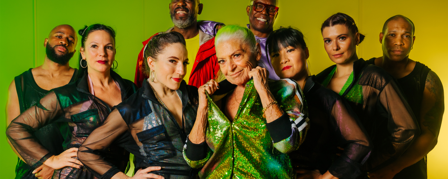 group of dancers on stage looking at camera with bright green and yellow backgdrop