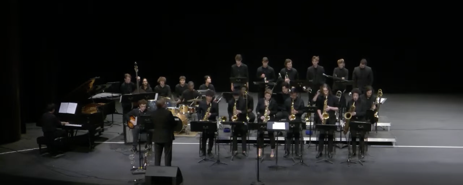 Group of musicians gathered on stage playing various instruments