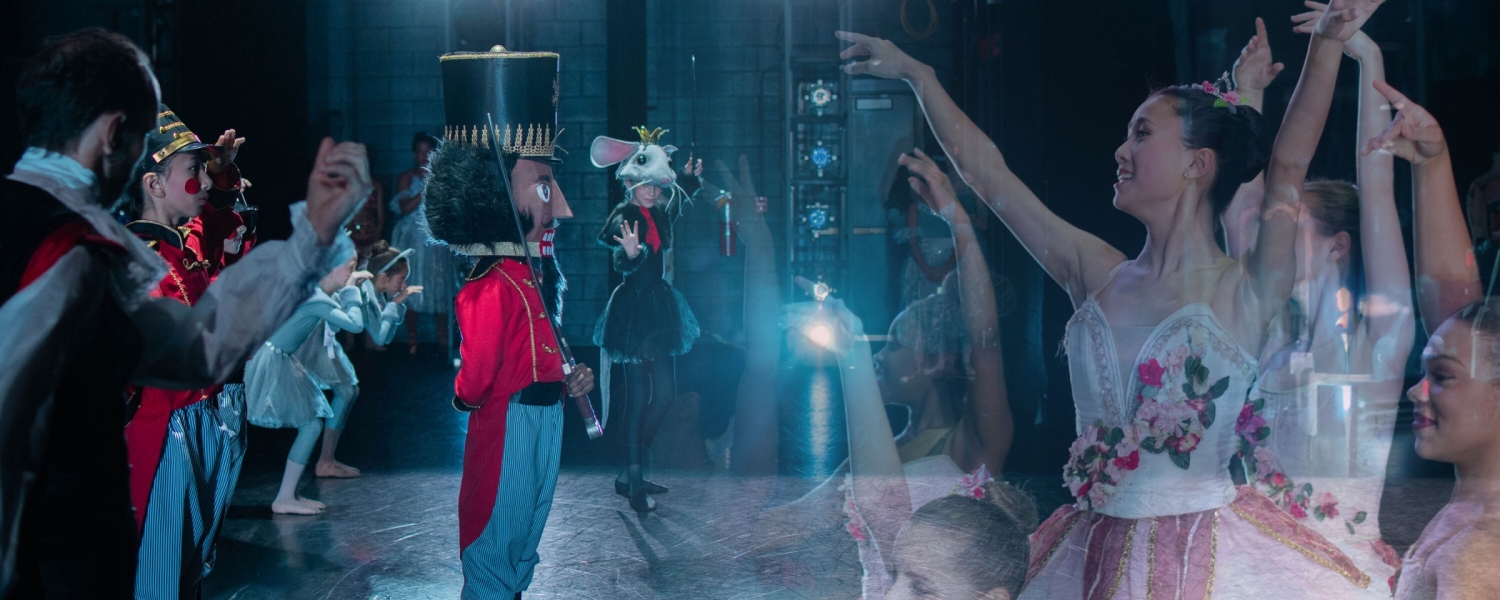Collage of nutcracker and ballet dancers with dark background and blue spotlight