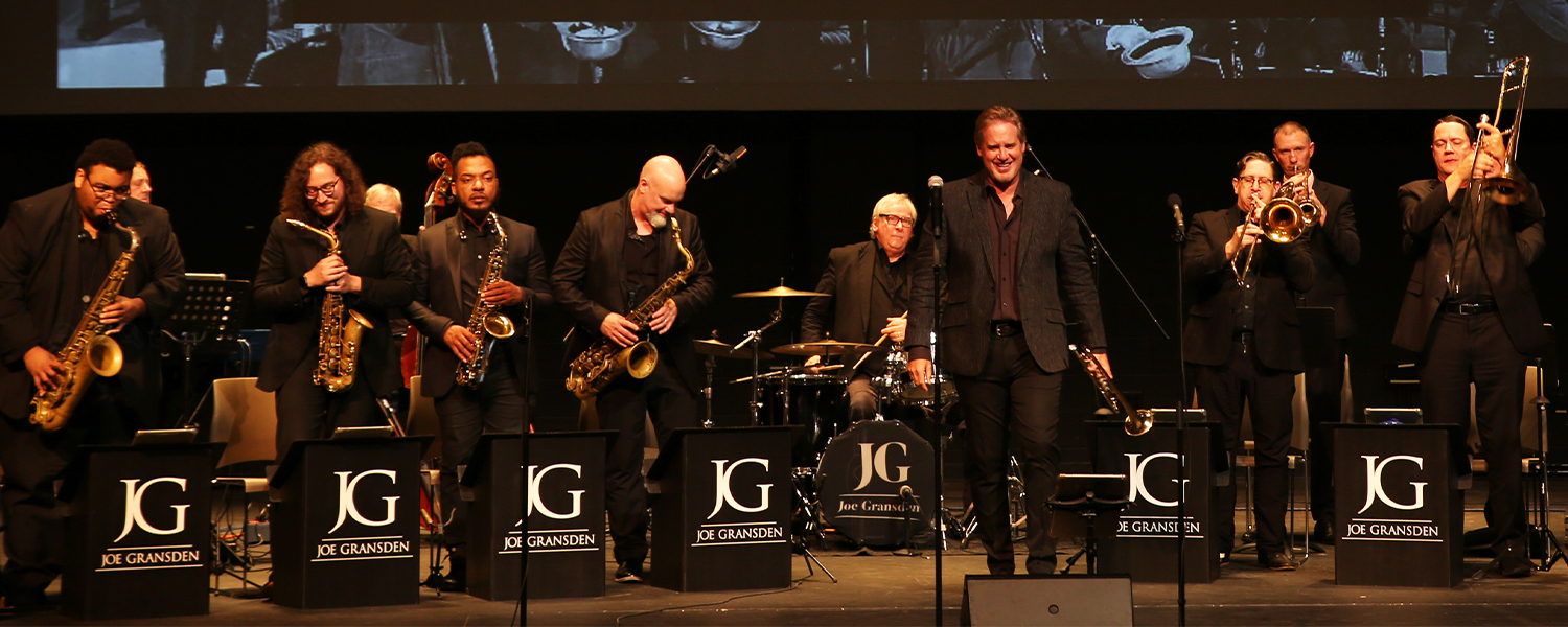 Joe Gransden on stage with his band to the left and right of him