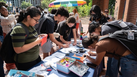 Students making paper chairs outside of the Ferst Center for The Arts.