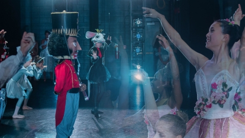 Collage of nutcracker and ballet dancers with dark background and blue spotlight