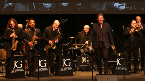 Joe Gransden on stage with his band to the left and right of him