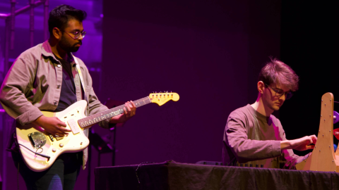 two people playing instruments with purple ambience
