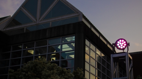 smithgall student services building at dusk with strobe light in purple