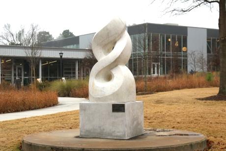 Smooth white marble, only lightly veined, sculpted as an abstract rendering of the olympic flame.