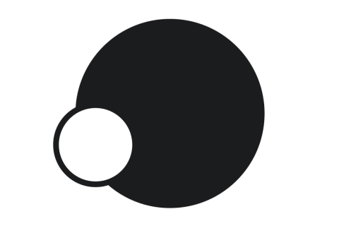 A graphic design with no text. A solid black circle, with a smaller white circle, bordered in black, partially overlapping the lower left side.