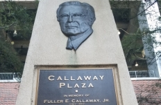 Bas relief of the face of Fuller E. Callaway, Jr. on a cement tower, above a plaque recounting his devotion and dedication to Georgia Tech