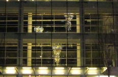 glass chandeliers seen through the three-story lobby glass windows of the Scheller College of Business