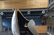 White aluminum amorphous shape with openings, suspended in the atrium of the Clough Undergraduate Learning Commons