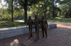 The figures of Ford Greene, Ralph Long Jr., and Lawrence Williams walking forward
