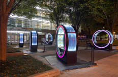 Six illuminated loops on a public plaza.