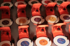 Colorful record players in rows.